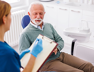Dentist answering patient’s questions about dental crowns in Plano