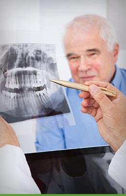 Dentist showing a patient their dental X rays