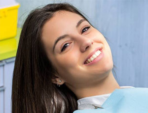 Smiling dental patient after porcelain veneer placement