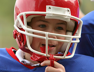 Boy with football helmet and mouthguard