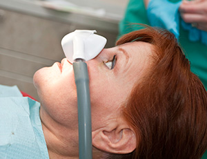 Woman in dental chair with nitrous oxide dental sedation mask