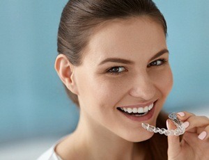 A woman inserting a clear aligner