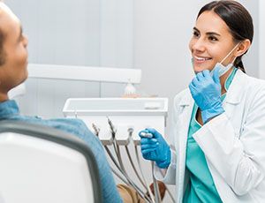 Dentist smiling at patient during consultation