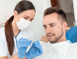 Dentist shows patient sportsguard