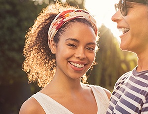 Young woman smiling after a visit to her Aetna dentist in Plano