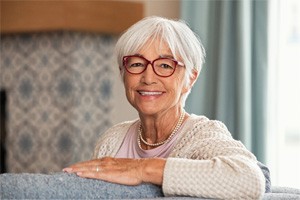 Senior woman on couch with All-on-4 in Plano, TX