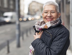 Woman smiling with dental bridge in Plano