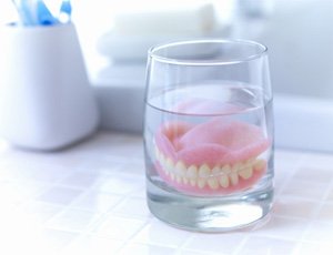 Dentures soaking in a solution