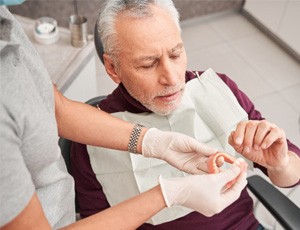 Man in the dental chair with his dentures