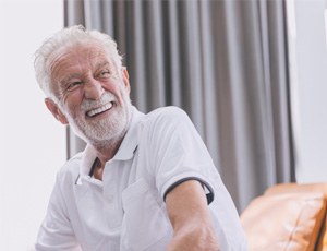 Man laughing while wearing dentures