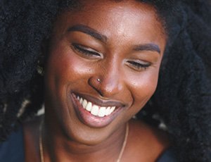 Laughing woman with beautiful smile after metal free dental restoration