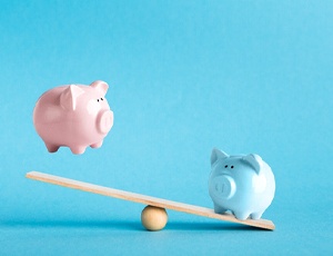 Piggy banks on balance scale