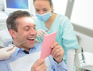 a patient checking his new dental crowns
