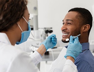 a patient smiling while undergoing a dental checkup