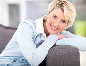 woman sitting on a gray couch