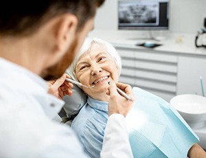 elderly woman at a dental implant consultation