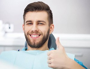 man giving a thumbs-up in the dental chair