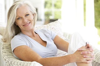 Older woman with an implant-retained denture.