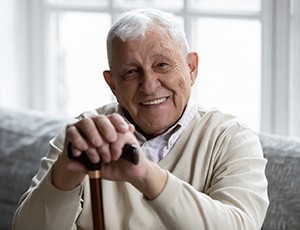 man smiling after getting dentures in Plano 