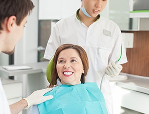 woman smiling after getting dentures 