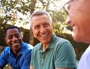 mature man happily talking to friends 