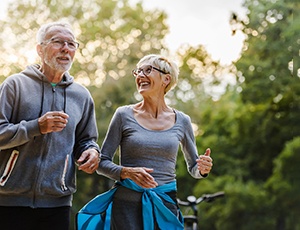 senior couple walking in park 