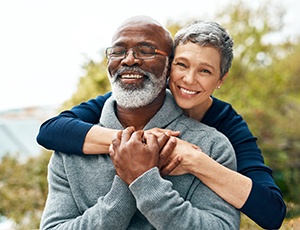 Senior man and woman outside and smiling