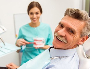 man with dentures at his dental appointment 