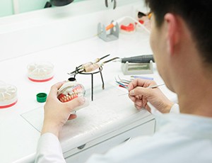 A technician making dentures for a patient
