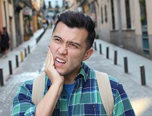 Walking man with questions for his Plano emergency dentist