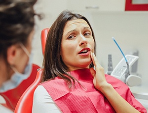 Woman at dentist needing tooth extraction in Plano