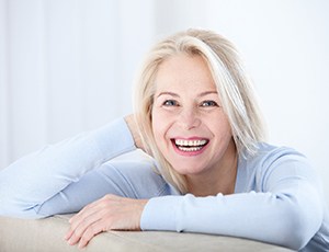 smiling woman sitting on a couch 
