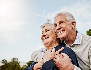 a mature couple smiling and spending time outdoors