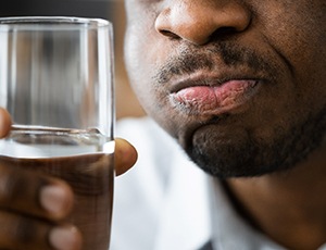 person rinsing their mouth with salt water