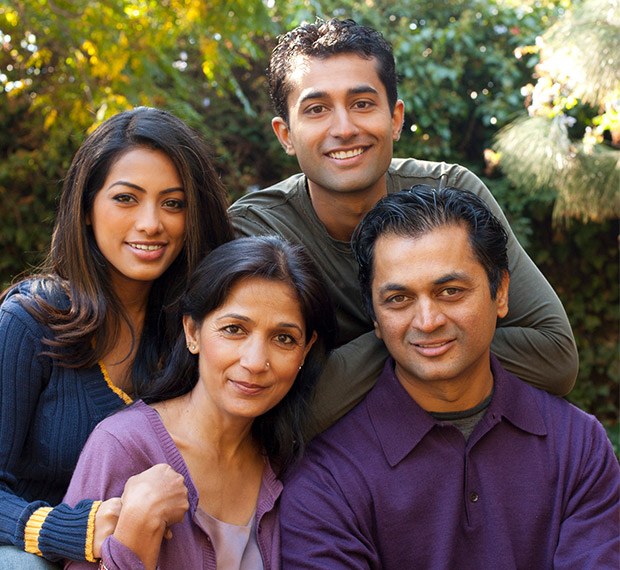 Family of four smiling outdoors