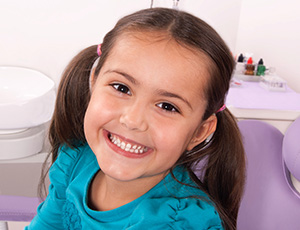 Smiling child in dental chair for pediatric dentistry