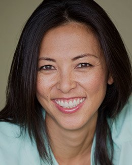 Woman in mint green shirt grinning