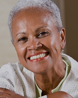 Senior woman with green shirt smiling