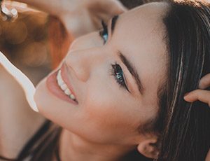 Young smiling woman after receiving dental services