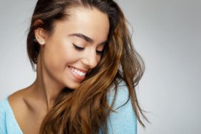 Woman with a beautiful smile after seeing a cosmetic dentist 