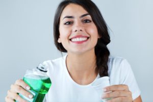 Woman using mouthwash
