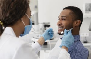 young man smiling at his dentist in Plano