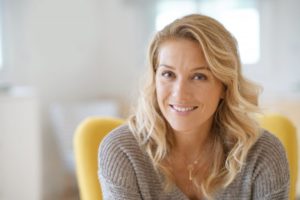 Woman smiling confidently with dental implants