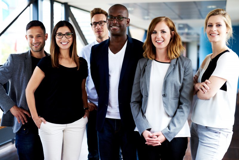 Group of professionally-dressed adults smiling