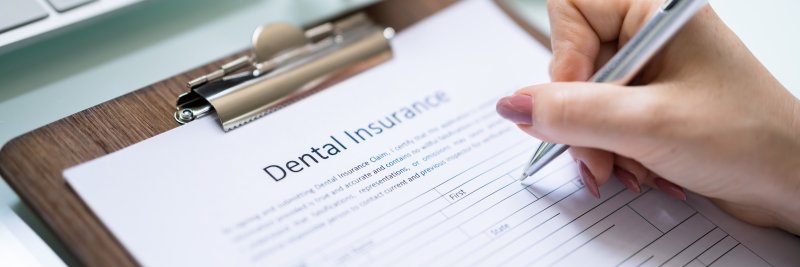 Patient filling out a dental insurance form