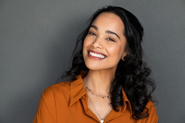 Woman smiling after receiving cosmetic dentistry.