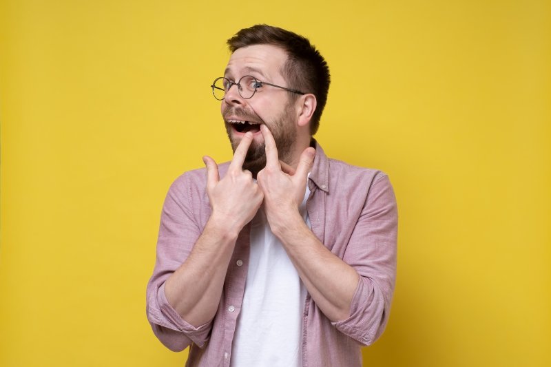 A man worried about his recent tooth loss