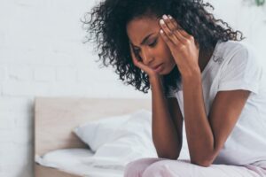 a woman with a headache holding her temples