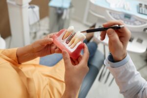 Patient learning about dental implant materials from dentist