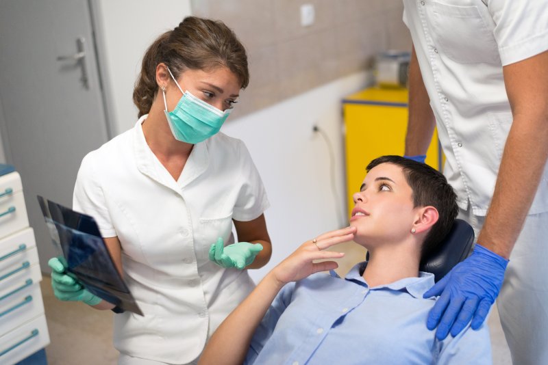 Patient smiling with dentist after TMJ disorder treatment